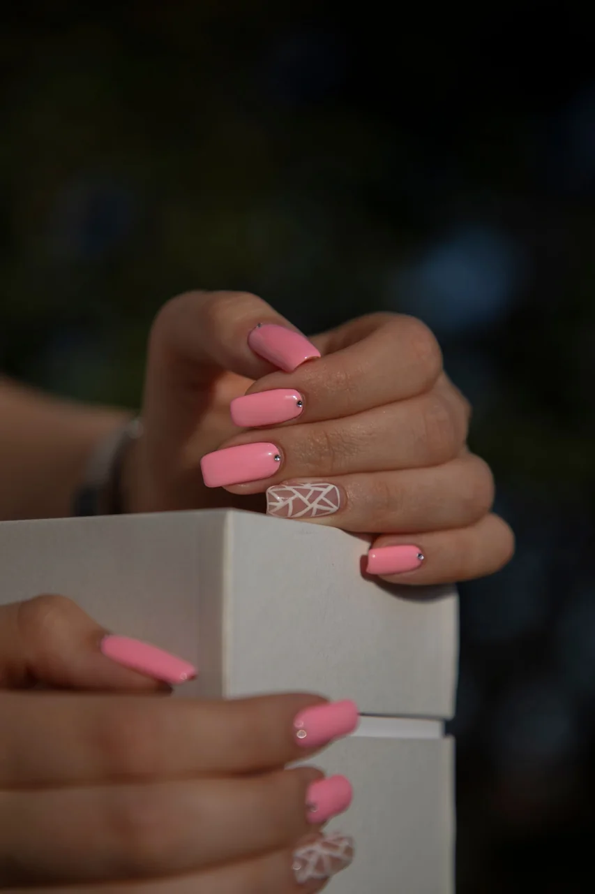 Sculptural manicure with artistic details in warm studio lighting